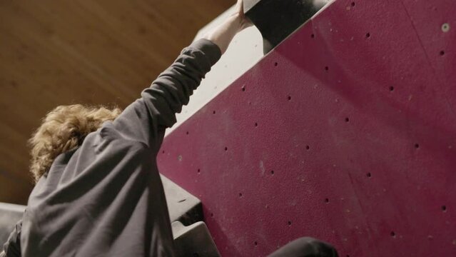 Rock Climber leaping to the next hold in slow motion