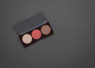 A box with three face shadows on a gray background. Flat lay.