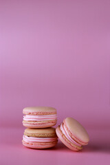 Fototapeta na wymiar macaroons with pink buttercream on a purple background with copy space