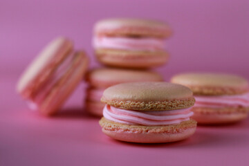 macaroons with pink buttercream on a purple background
