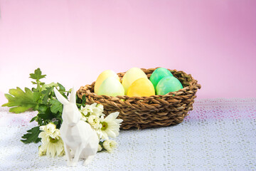 Easter background with rabbit, colorful eggs and flowers