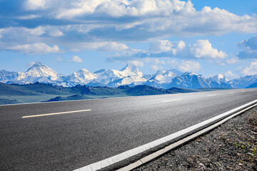 Asphalt road and snow mountain with beautiful sky clouds under blue sky