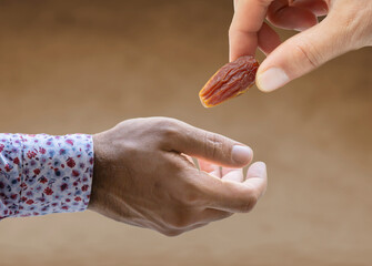 hand giving dates on isolated white background