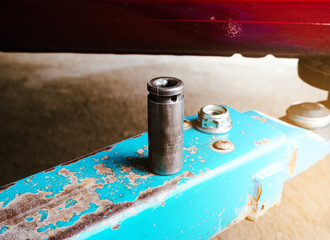 Metal block of air impact wrench on the car hydraulic lift