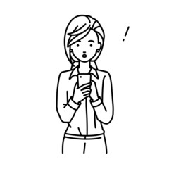Fototapeta premium 立ってスマートフォンを操作して何かに気づいて驚いたブラウスの女性