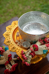 Flower garlands, water bowls, perfume and white clay filler for Buddha bathing ceremony on important religious days for Buddhists, New Year's and Songkran Festivals for Asians.