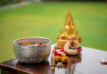Flower garlands, water bowls, perfume and white clay filler for Buddha bathing ceremony on important religious days for Buddhists, New Year's and Songkran Festivals for Asians.