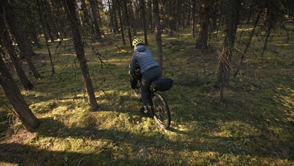The woman travel on mixed terrain cycle touring with bike bikepacking outdoor. The traveler journey...