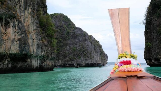 A wooden long tail boat sailing in the sea of Phi Phi Island