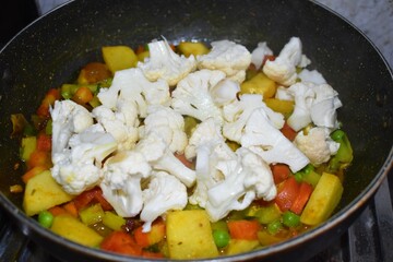Cooking mix vegetables in a pan in India, Healthy food concept.