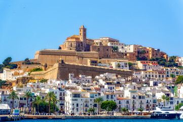 A sea side view to the Ibiza Old Town with Cathedral of Santa Maria d`Eivissa at the top of the hill in Ibiza, Spain. - obrazy, fototapety, plakaty