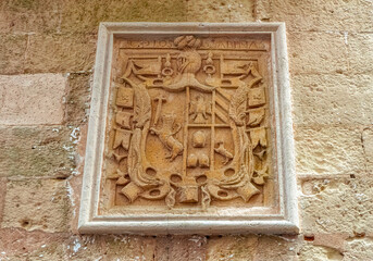 Old coat of arms incorporated into old wall of Old Town at Ibiza, Spain.