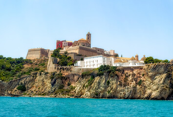 A view from the sea side to the Ibiza Old Town with Cathedral of Santa Maria d`Eivissa at the top of the hill in Ibiza, Spain.