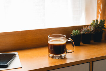 Coffee Morning,Coffee in a mug on a wooden table with a notebook