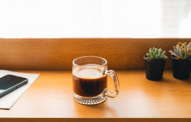 Coffee Morning,Coffee in a mug on a wooden table with a notebook