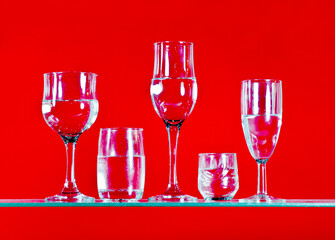 arious drinks filled with water are placed on a bright red background