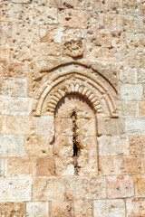 Fototapeta na wymiar Old wall damaged by gun bullets in last war in Jerusalem, Israel.