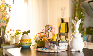 Easter time. Easter decorations on the shining wooden table. Easter bunny, easter eggs in basket and cabbage leaf.