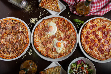 High angle view of traditional Italian food , variety of pizzas