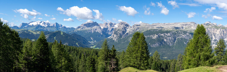 Fototapeta na wymiar Amazing landscape at the Dolomites in Italy. View at Sella group and Marmolada with its glaciers. Alta Badia, Sud Tirol, Italy. Summer time. dolomiti best of Italy. Alpine contest
