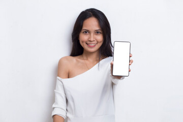 young beautiful asian woman demonstrating mobile cell phone isolated on white background
