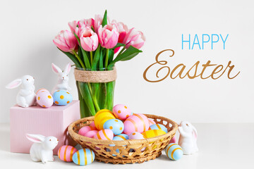 Pink tulips, easter bunnies with colorful eggs in basket, Easter concept.