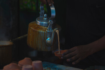 Indian traditionally tea making process in a road side tea stall. 