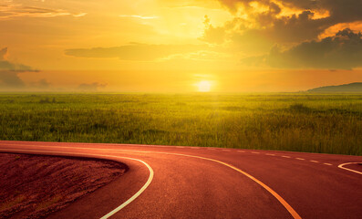 Asphalt curve road, sunset and beautiful roadside views in the countryside.