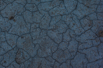 Texture of the dried earth. Dark gray background with cracks and hollows. Drought and lack of...