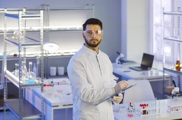 Portrait of serious researcher conducting scientific research in modern medical laboratory. Young...