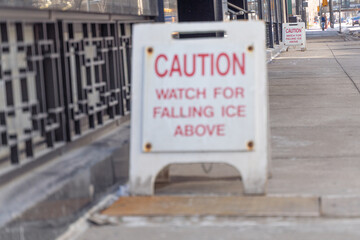 Falling Ice caution sign on a calgary city street in winter