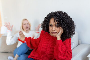Dont want to hear. Unhappy disturbed tired woman communicating with her friend sitting near her on...