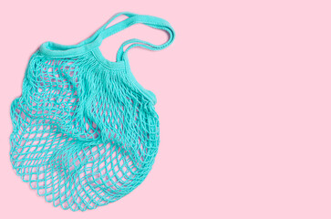 Eco shopping bag on pink background. Top view, copy space.