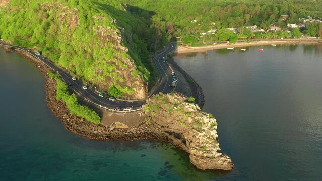 Maconde beach bathing in beautiful sunlight with amazing surrounding landscape. Aerial shot of beautiful Mauritius scenery.
