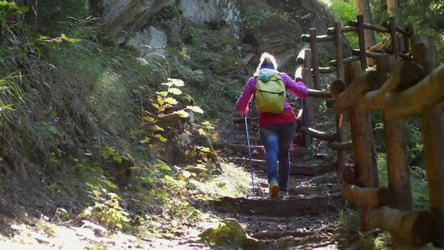 Woman trekking in a steep mountain path. Slow motion 4K