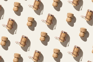 Pattern with champagne corks on beige background with hard light and shadow at sunlight. Summer...