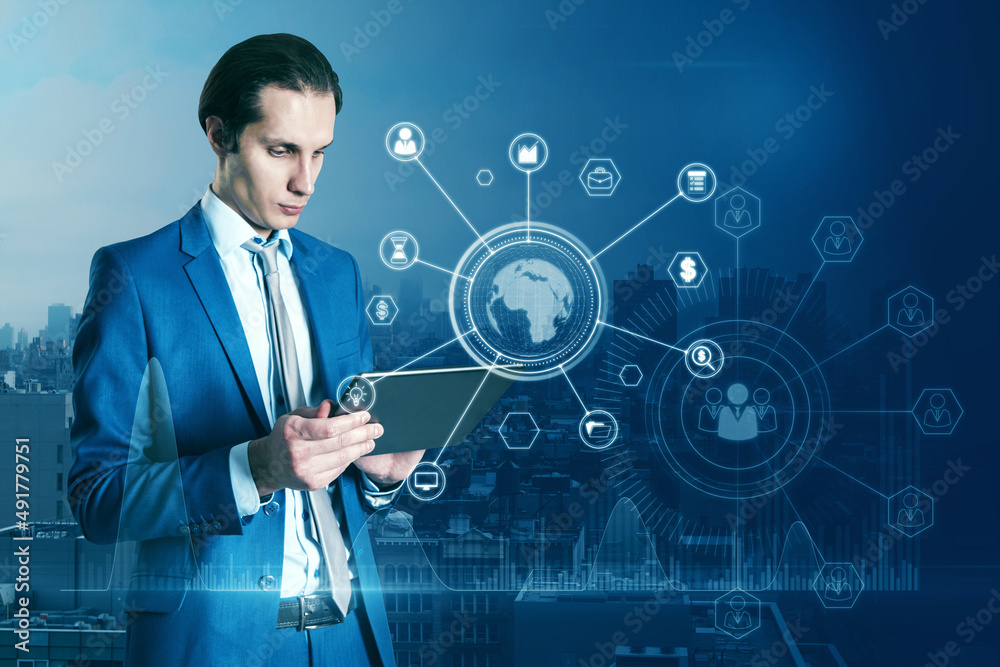 Aufkleber Portrait of attractive businessman hand pointing at tablet with abstract glowing business data and earth hologram on blurry blue city background. Communication and media concept. Double exposure.