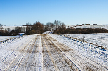 Winter road covered with sand. The road is covered with sand to increase the friction force of the wheels on the ice.
