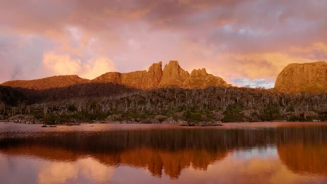 panning left shot of mt geryon and lake elysia during a dramatic red sunset at the labyrinth in cradle mountain-lake st clair national park of tasmania, australia