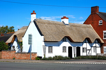 Pretty traditional English whitewashed thatched cottage in the village centre, Kings Bromley, Staffordshire, UK.