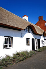 Pretty traditional English whitewashed thatched cottage in the village centre, Kings Bromley, Staffordshire, UK.