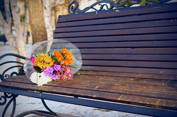 Bouquet of flowers on a bench