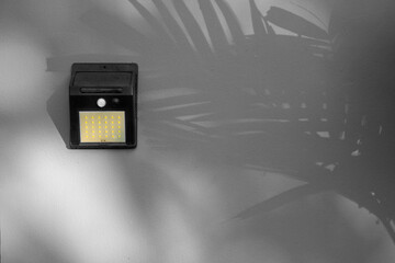 copy space of Solar-powered motion sensor light isolated on cement or concrete wall background,