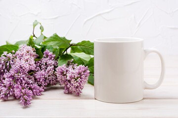 White coffee mug mockup with beutiful lilac bouquet
