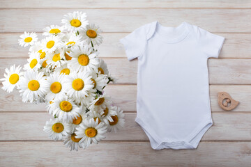 White baby short sleeve bodysuit mockup with daisy and bird toy