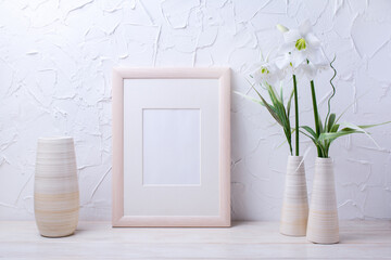 Wooden frame mockup with lily and striped vase