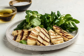 Grilled Halloumi cheese salad on white plate, Cyprus squeaky cheese. Restaurant menu, dieting, cookbook recipe top view