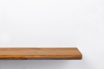 empty wooden shelf on the wall