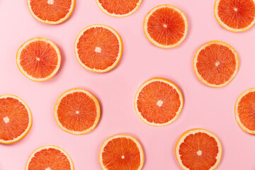 grapefruit slices on pink background