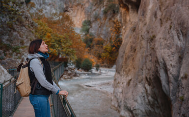 Happy asian woman is enjoy active hiking along the Saklikent Gorge in Turkey. New experience and outdoor leisure recreation